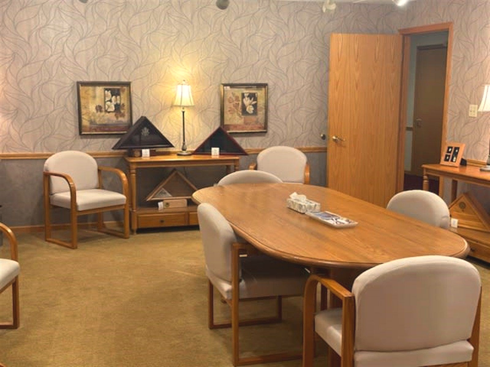 A funeral director at Gephart Funeral Home meets with a family in the arrangement room.