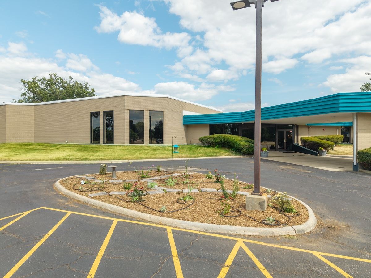 The outdoor monument sign for Grace Funeral & Cremation Services and Faithful Friends Pet Funeral & Cremation Services on the landscaped grounds in Rockford, IL.
