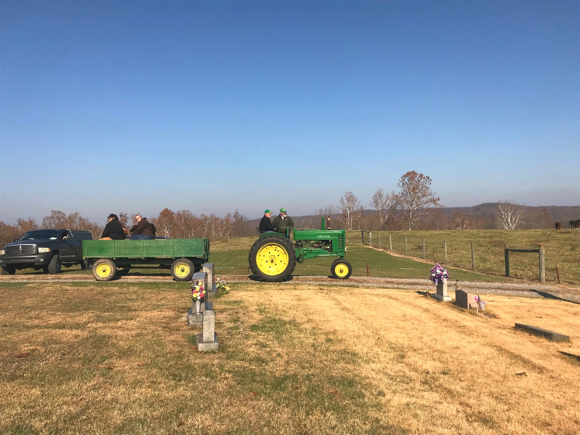 A vintage tractor leads a memorial procession through a rural Jackson County cemetery, one example of the personalized farm-heritage tributes Spurgeon Funeral Home arranges for Vallonia-area families.